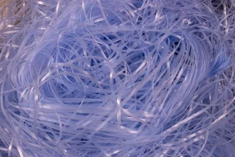 Blue shredded plastic fake Easter grass background Foto stock