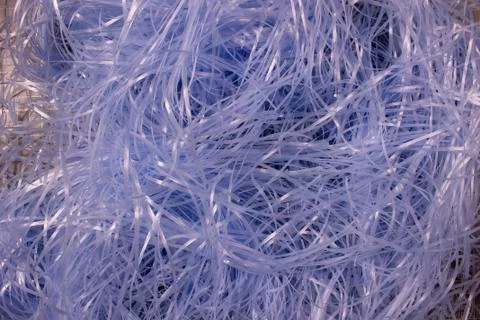 Blue shredded plastic fake Easter grass background Stock Photos