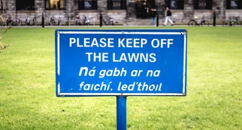 Blue sign Please Keep off the Laws in English Stock Photos