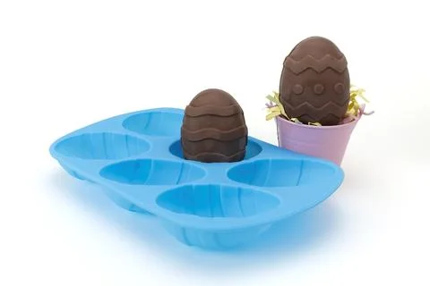 Blue Silicone Easter Egg Mold and Homemade Chocolate Eggs Standing Up Stock Photos