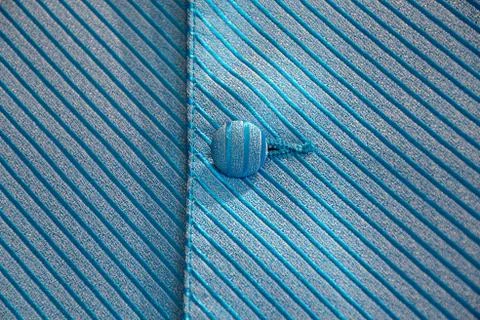 Blue silk button on vest Stock Photos