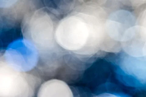 Blue silver blur circle lights as background. Stock Photos