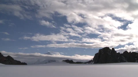 Blue skies and thin bright clouds, mountain and glacier, Antarctica Stock Footage 34311094