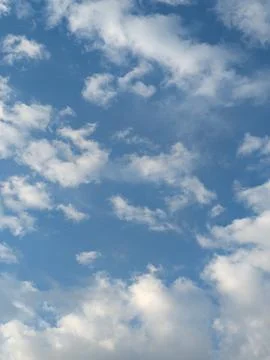 Blue Skies with wispy lines and fluffy white clouds Stock Photos