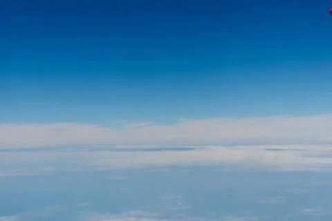 Blue sky above soft clouds Stock Photos