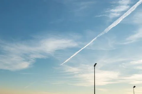 Blue sky with airplane trace Stock Photos