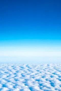 Blue sky and Cloud Top view from airplane window,Nature background. Stock Photos