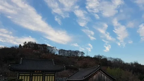 Blue sky and clouds above Korean traditional houses-time lapse Stock Footage 257389137