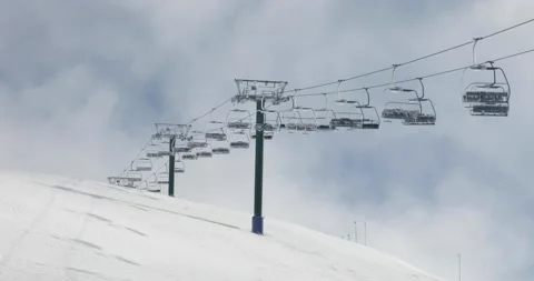 Blue Sky and Clouds Behind Closed Down Chairlift in Winter Covid 19 Shutdown Video stock 137858843