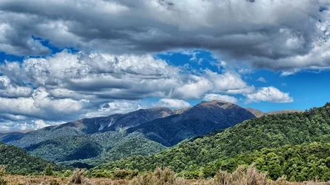 Blue Sky and Clouds over Mountain Range 4k Time Lapse Footage 動画素材 108345459