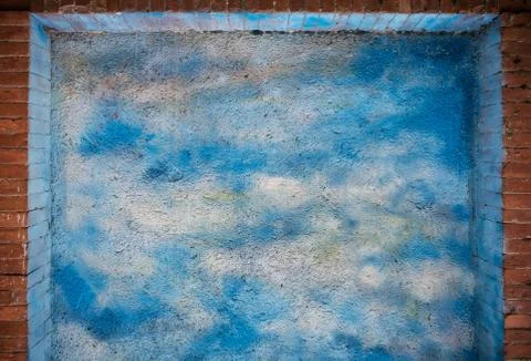 Blue sky and clouds over brick wall texture or background Foto stock