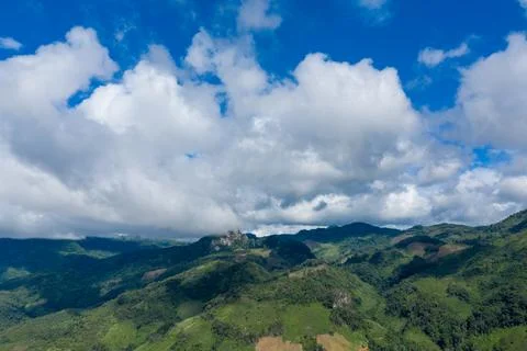 Blue sky and clouds over green mountain hills Stock Photos