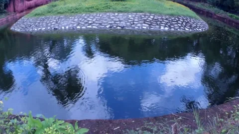 Blue Sky and Clouds Reflect On Small Pond Water Stock Footage 218448640