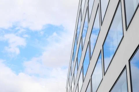 Blue sky and clouds reflected windows of modern building Stock Photos