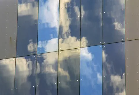 Blue Sky and Clouds Reflected in Glass Facade Stock Photos