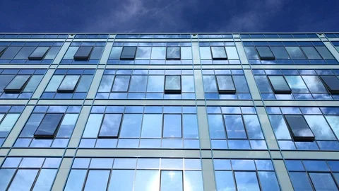 Blue sky and clouds reflecting in business building windows Stock Footage 104202994