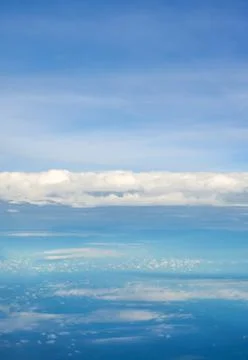 Blue sky and clouds view from airplane window. Stock Photos
