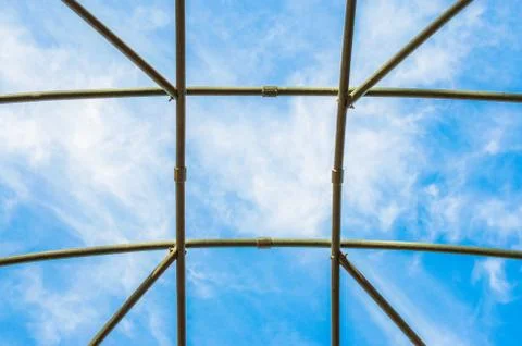 Blue sky and clouds viewed through a lattice Stock Photos