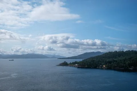Blue sky and delicate clouds watch over morning in Norway near Leirvik 写真素材
