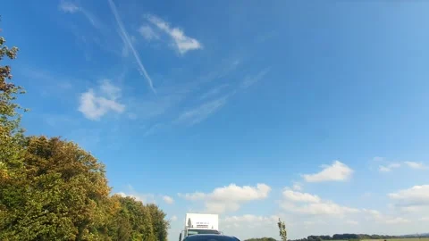 Blue Sky and Few Clouds over England During Car Drive Stock Footage 320139484