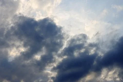 Blue sky and heavy clouds and the sun behind Foto stock
