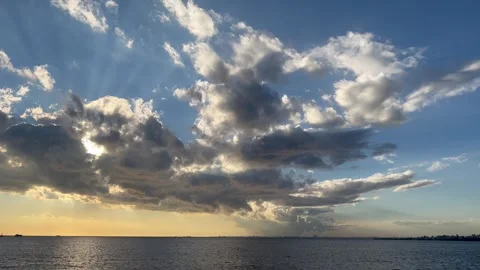 Blue sky and large cloud cluster forming with diffuse clouds around. Scenic view Stock Footage 250875636