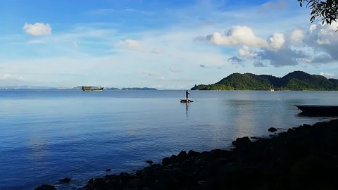 Blue sky and man in the ocean Stock Footage 107729062