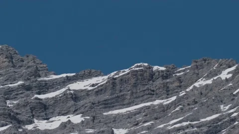 Blue sky and mountain top snow melting Stock Footage 187741783