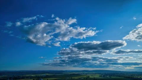 Blue sky and multiple clouds background Stock Photos