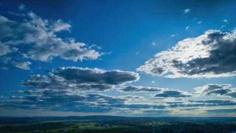Blue sky and multiple clouds background Stock Photos