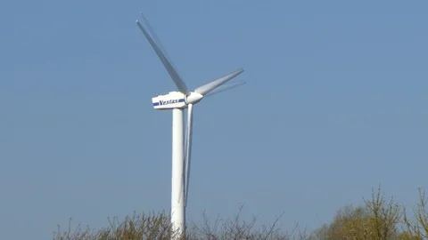 Blue sky and rotating wind turbine - slow motion Stock Footage 106705963