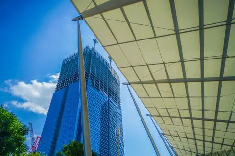 Blue sky and skyscraper construction Stock Photos