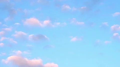Blue sky and small pink clouds background Vídeo Stock 340488815