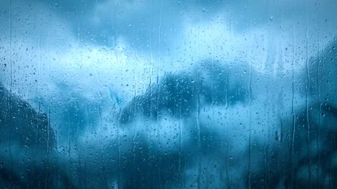 Blue sky and storm clouds behind a frosted rainy window. 4K Video stock 343244040