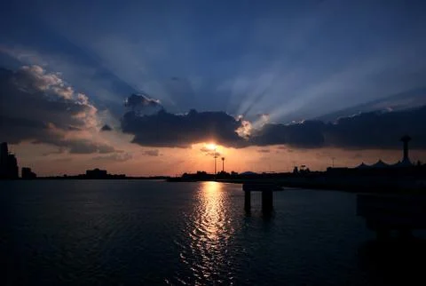Blue sky and sun rays. Sunset over Abu Dhabi, United Arab Emirates Stock Photos