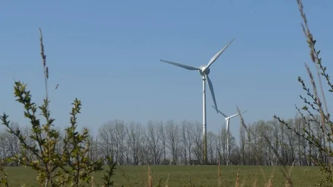 Blue sky and two rotating wind turbines Stock Footage 106697940