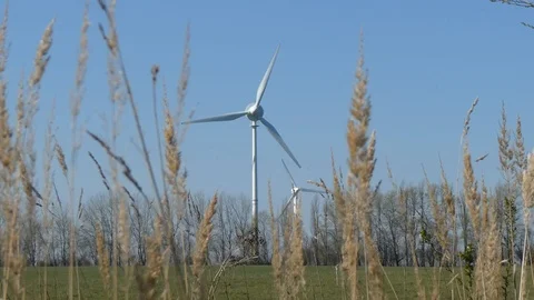 Blue sky and two rotating wind turbines Stock Footage 106699214
