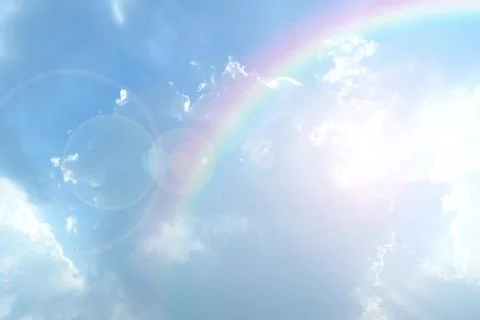 Blue sky and white cloud with sun light and rainbow Stock Photos