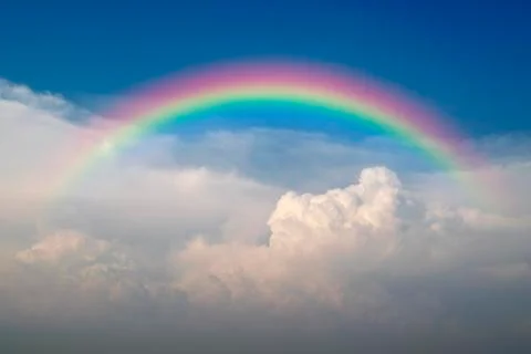 Blue sky and white cloud with sun light and rainbow Stock Photos