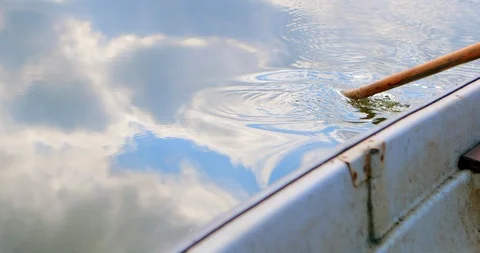 Blue sky and white clouds reflected in the water.  A romantic boat ride. Video stock 116050546