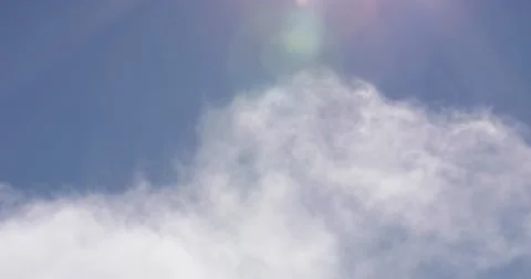 Blue Sky and White Clouds Drifting By With Lens Flare Close Up 4K 10 Stock Footage 137598382