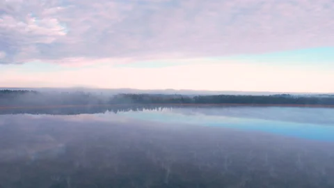 Blue sky and white clouds, mirror image. Flying low over the water. 動画素材 169027670
