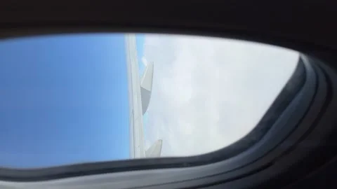 Blue sky and white clouds in airplane window. Vertical video Stock Footage 199040793