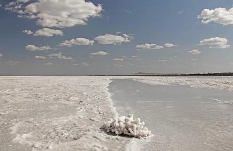 Blue sky and white clouds on the lake. Salt Lake Baskunchak, Russia. Stock Photos
