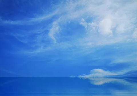 Blue sky and white clouds reflected on the water surface. Stock Photos