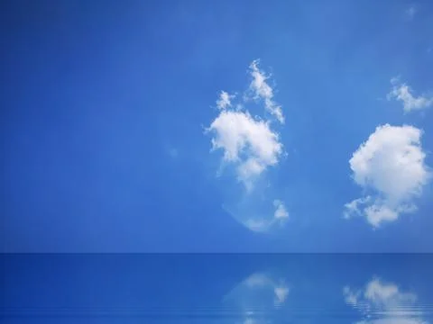 Blue sky and white clouds reflected on the water surface. Stock Photos