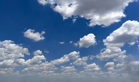 Blue sky and white clouds. Summer sky carries cumulus clouds. Sunny sky fra.. Stock Photos