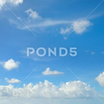 Blue sky and white cumulus clouds Stock Photos
