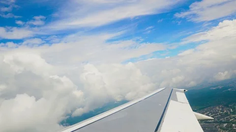 Blue sky and white heap clouds looking through porthole of flying airplane 4k Stock Footage 107742088