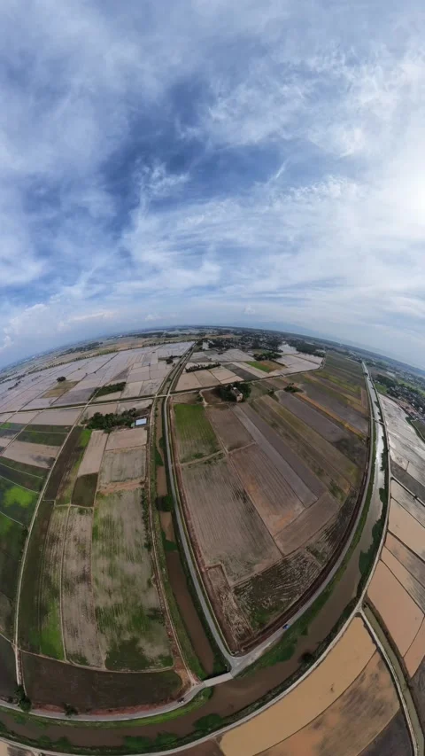 Blue sky arches over vast farmland patches Stock Footage 345409329